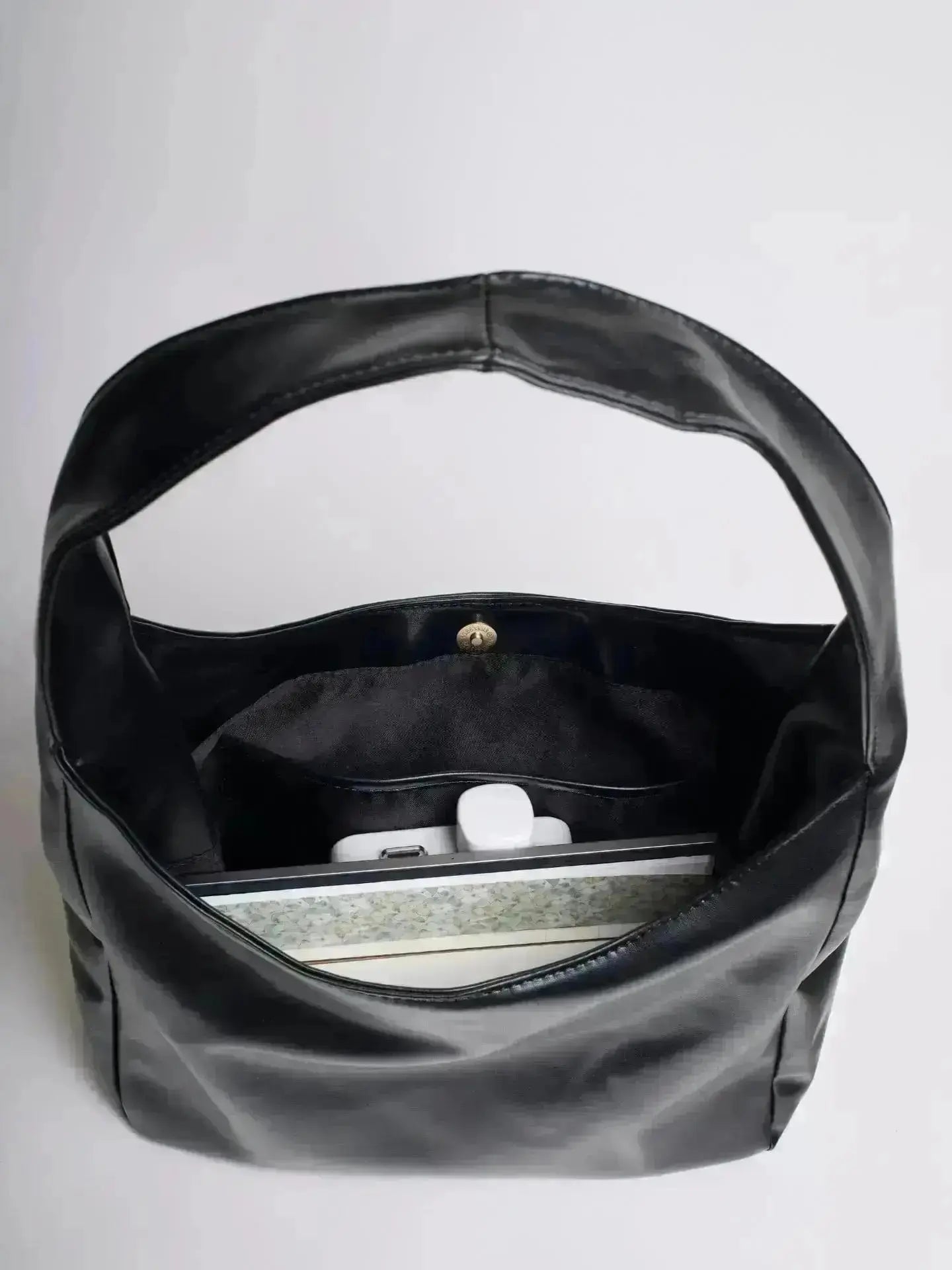 Reinforced handle detail on leather bucket bag