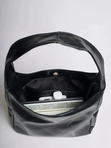 Reinforced handle detail on leather bucket bag
