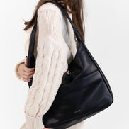 The Maya hobo bag in black leather, front view