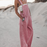 Pink wide-leg overalls with distressed denim detailing, front view