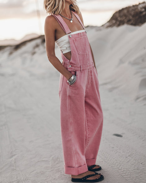 Pink wide-leg overalls with distressed denim detailing, front view