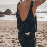 Woman wearing dark low back tank top at the beach