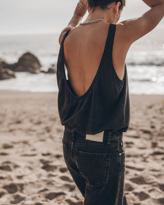Woman wearing dark low back tank top at the beach